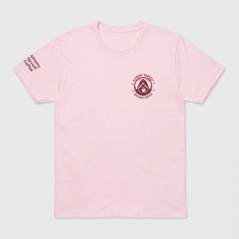 A light pink short-sleeve crewneck t-shirt with a dark red circular logo on the left chest and vertical text on the right sleeve, displayed flat against a light gray background.