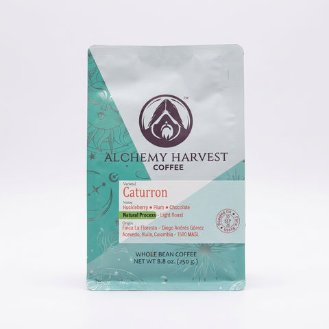 A 8.8 oz bag of Alchemy Harvest Coffee Caturrón whole bean coffee, featuring a silver and teal design with a white label, set against a plain white background.