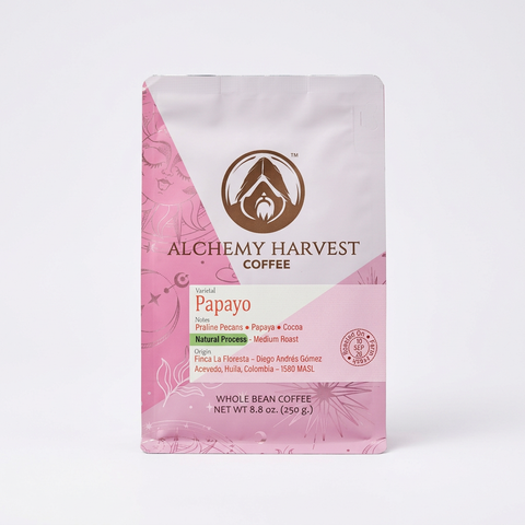 A 8.8 oz bag of Alchemy Harvest Coffee's Papayo variety, featuring a pink and white design with a brown logo, set against a plain white background.