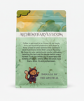 Green coffee bag with Alchemy Harvest branding on a beige background