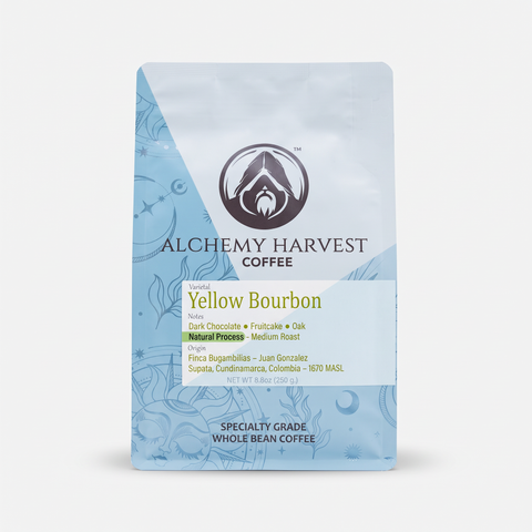 A stand-up coffee bag labeled Alchemy Harvest Coffee Yellow Bourbon, shown on a clean white background. The packaging is light blue with darker blue decorative line art and a central white label area with black and yellow text.