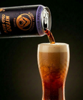 Can of Alchemy Harvest Coffee Nitro Cold Brew being poured into a glass.
