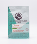 A 8.8 oz bag of Alchemy Harvest Coffee Caturrón whole bean coffee, featuring a silver and teal design with a white label, set against a plain white background.