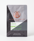 Alchemy Harvest Coffee package on a beige background