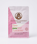 A 8.8 oz bag of Alchemy Harvest Coffee's Papayo variety, featuring a pink and white design with a brown logo, set against a plain white background.